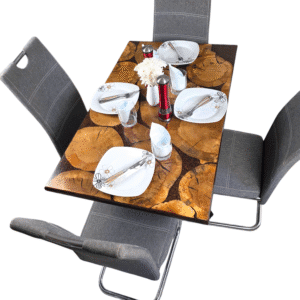 A unique and handcrafted epoxy resin table. The tabletop features a mosaic of irregularly shaped, light brown wood slices embedded within a dark brown, glossy epoxy resin. Some of the wood slices display visible tree rings and natural cracks. The resin is smooth and reflective, catching the light. The table has a dark brown wooden edge and rests on sturdy black legs. The table is a stylish, nature-inspired piece of furniture with a modern touch.