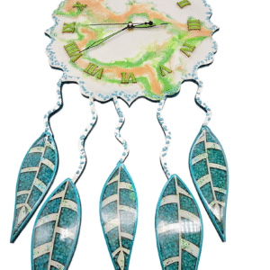 A handmade clock with a white, marbled face with swirls of peach and green resin.