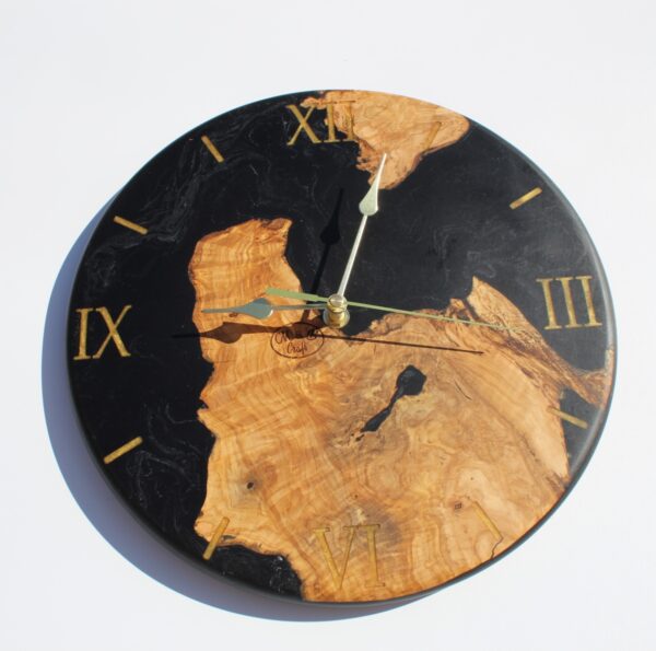 IMG_1857 - Future Investments Natural wood finish, Black resin accents, Elegant gold Roman numerals, Handcrafted wall clock.