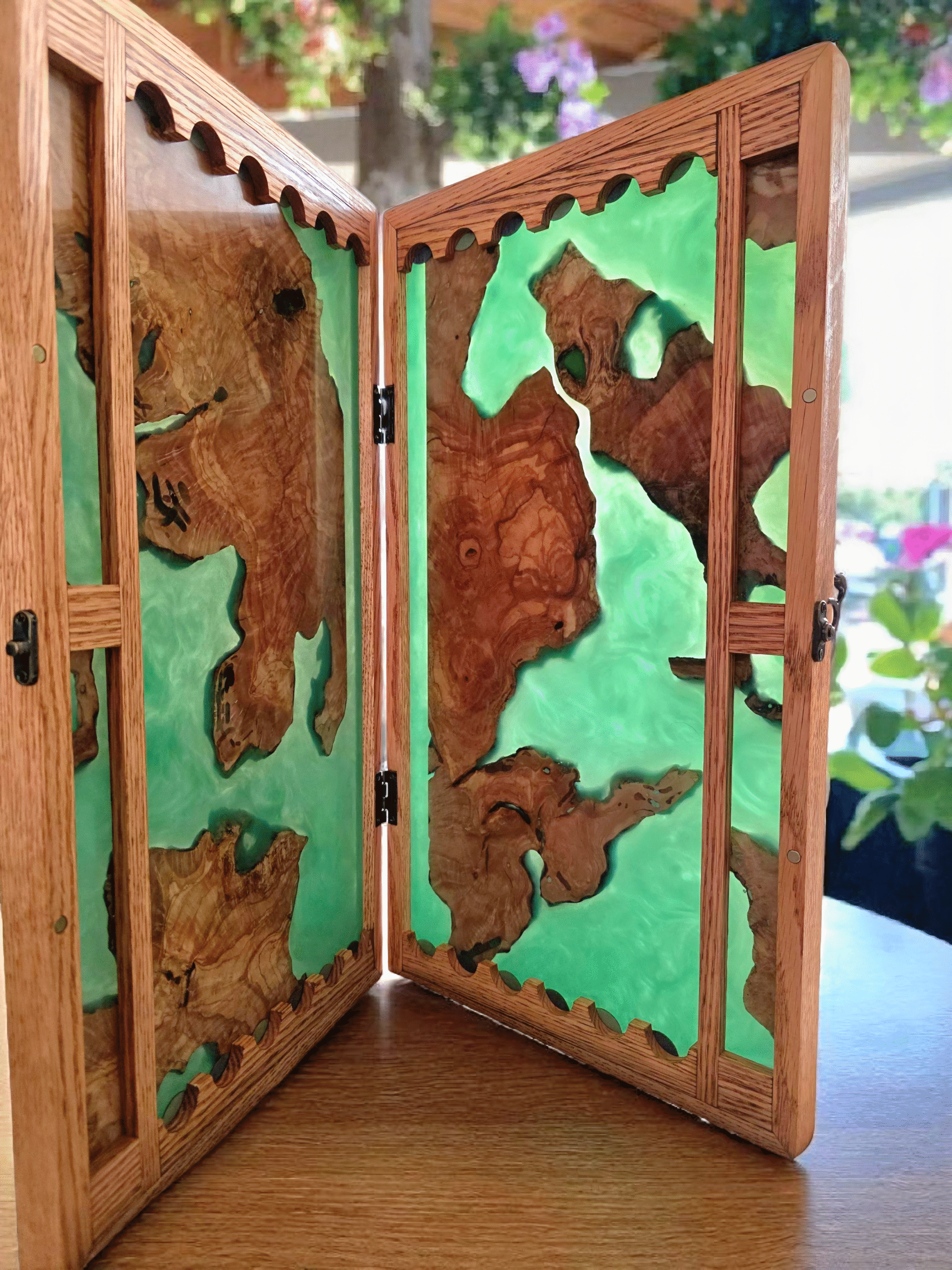 Handcrafted olive wood and green resin backgammon board on a table with coffee and boo