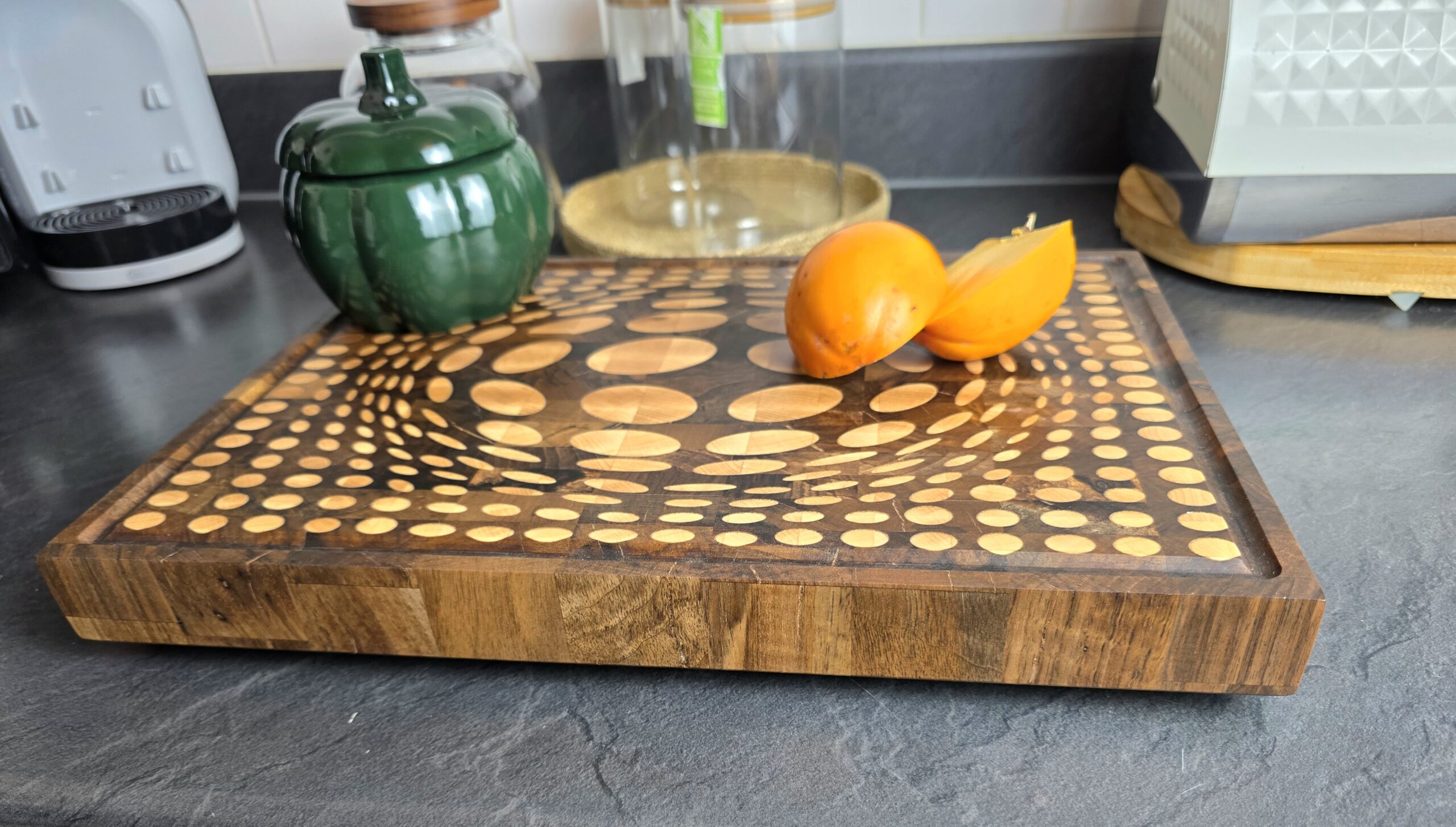 20260120_171427 - M & B CRAFT Side profile of 4cm thick heavy-duty butcher block. Close up of end-grain wood construction, deep juice groove, and recessed handle grips. Romanian walnut and maple layers.