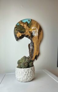 Large Cretan Olive Wood wall clock with teal resin river. Features white resin eagle inlay and walnut wood inlaid hour markers.