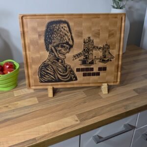 Solid maple cutting board resting upright on a custom spalted maple display stand.