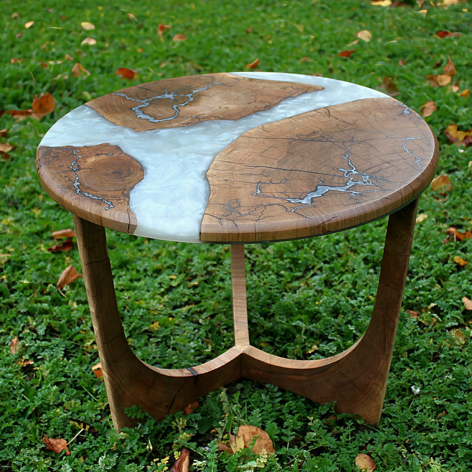 IMG_2250 - M & B CRAFT A round handcrafted walnut wood coffee table featuring a metallic pearl resin river running through the center, detailed with silver-inlaid Lichtenberg fractal lightning patterns on a custom sculpted wooden base,