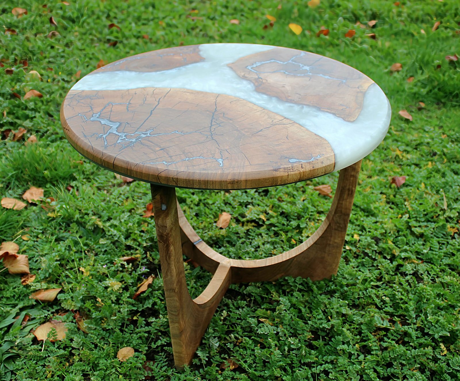 IMG_2260 - M & B CRAFT A round handcrafted walnut wood coffee table featuring a metallic pearl resin river running through the center, detailed with silver-inlaid Lichtenberg fractal lightning patterns on a custom sculpted wooden base,
