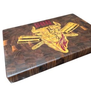 Extra-large end grain walnut meat carving board featuring a massive bull head, crossed meat cleavers, and 'BBQ' lettering inlaid with maple and purple heart wood.