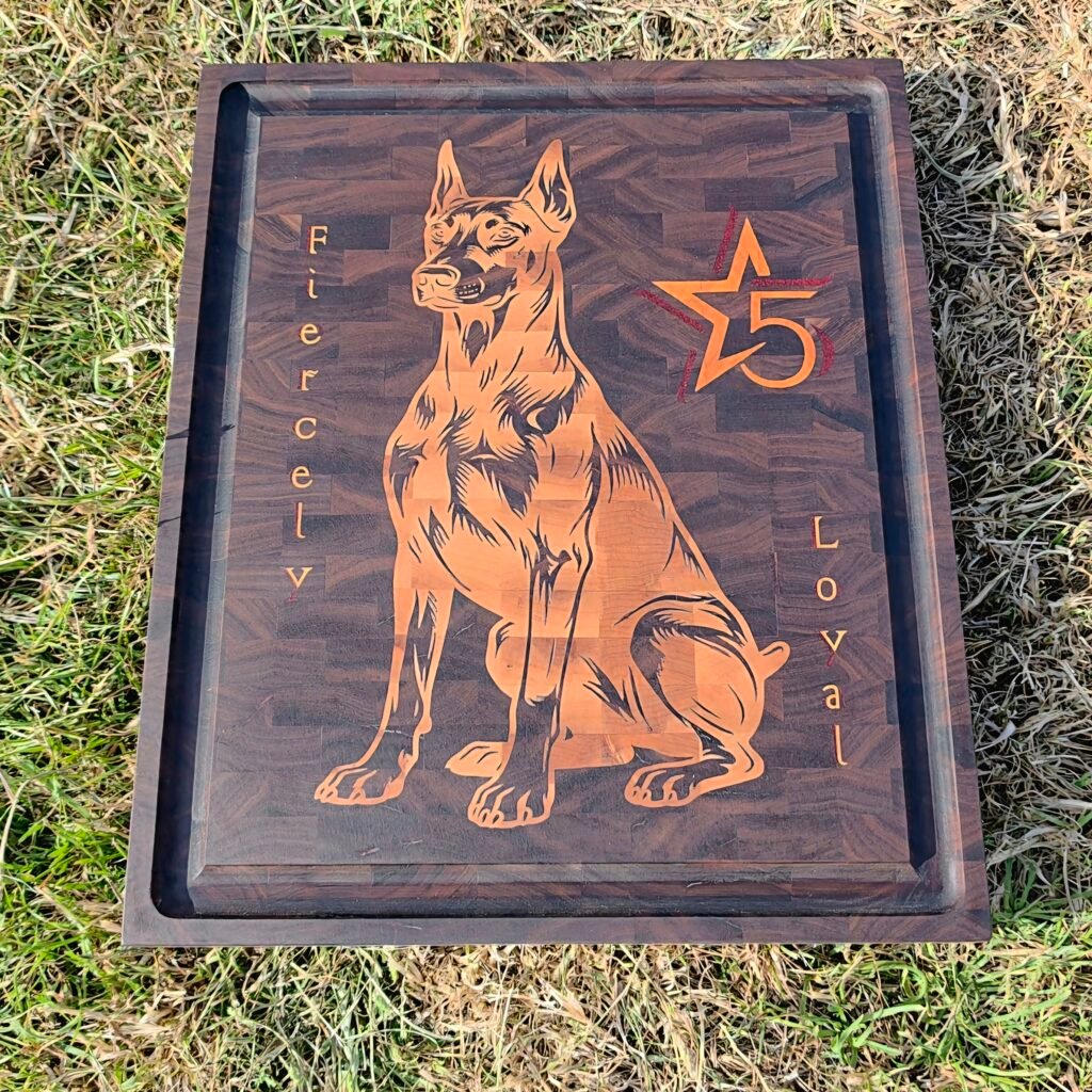 Carved wooden sign featuring a German Shepherd silhouette, with an orange number 5 and star motif on grass.